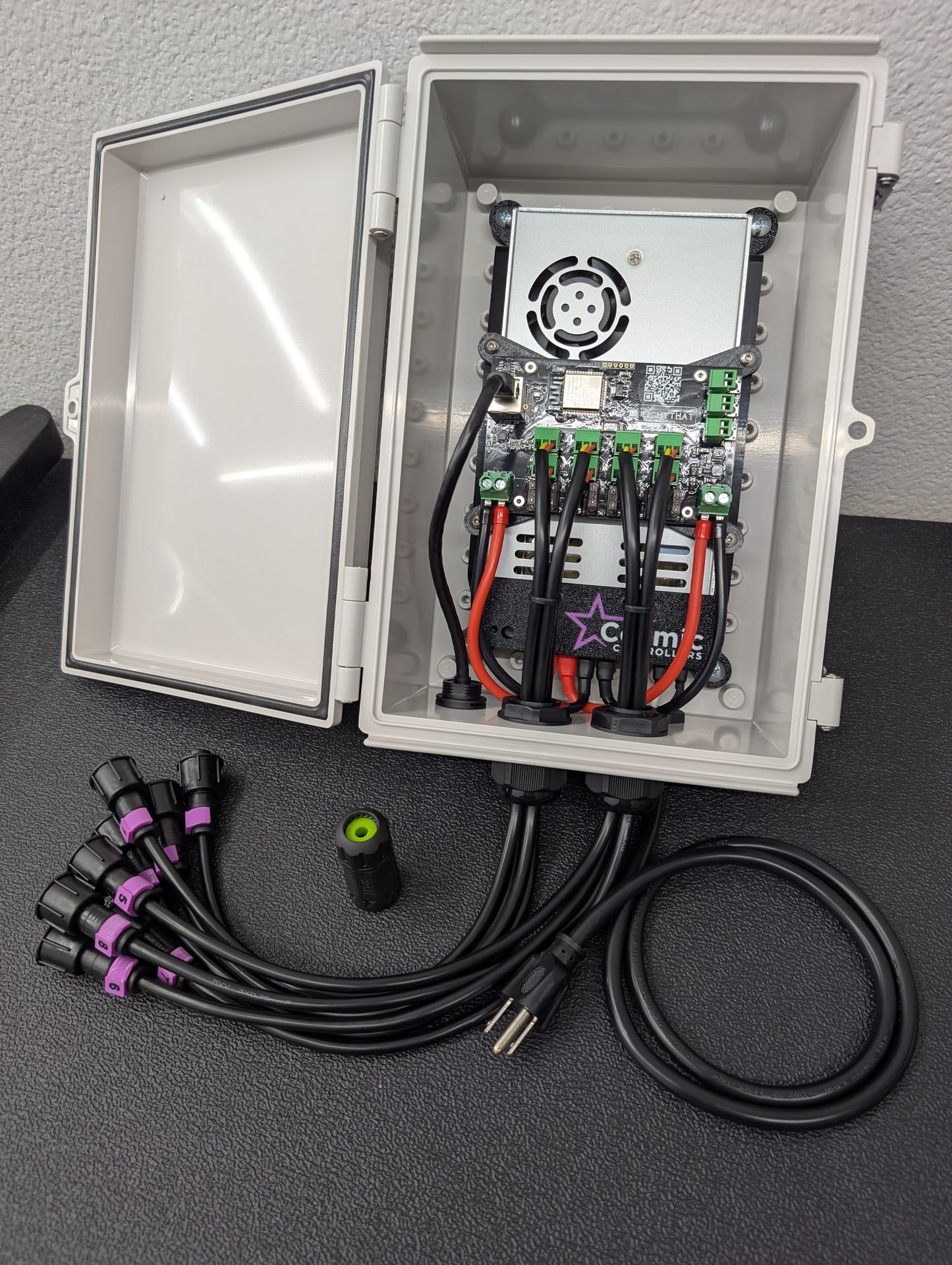 Gray waterproof enclosure with a LED controller, power supply, and wiring inside.