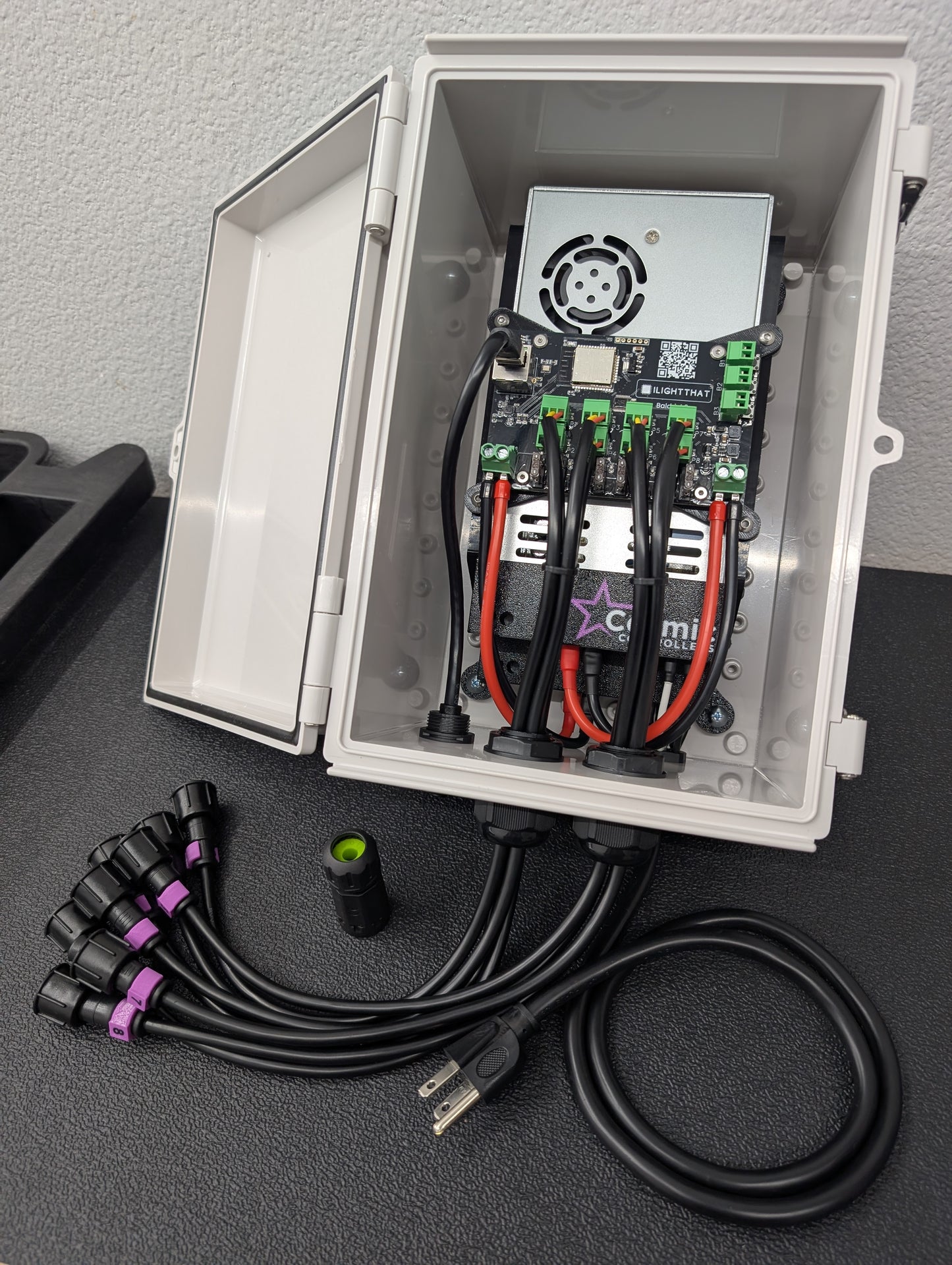 Open gray waterproof pixel controller enclosure showing electrical components and wiring inside