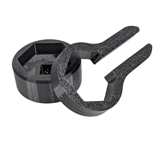 Close up view of two black M25 cable gland tools on a white background.