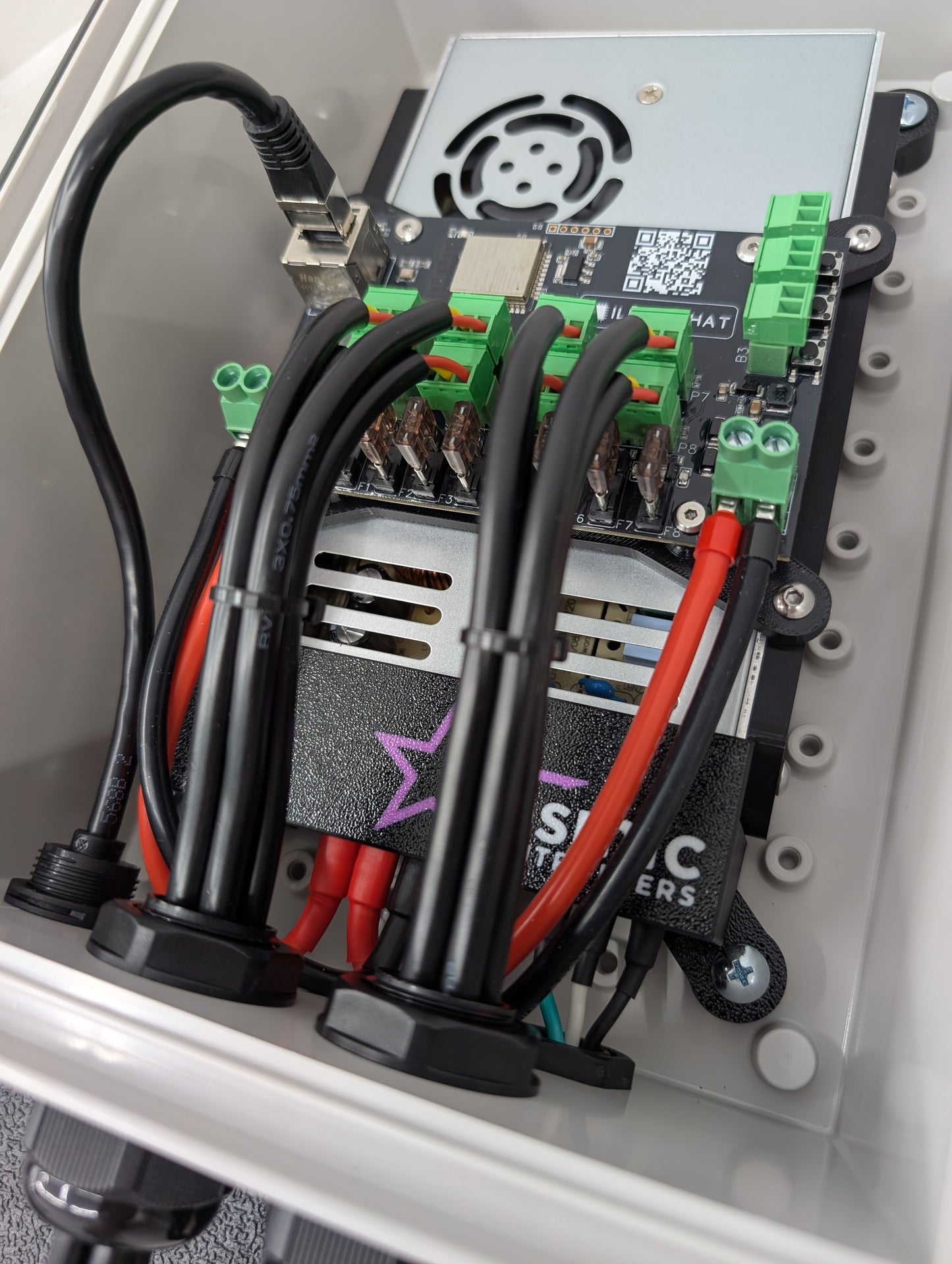 Inside of waterproof enclosure containing two power supply, wiring, and a Baldrick8 pixel controller.