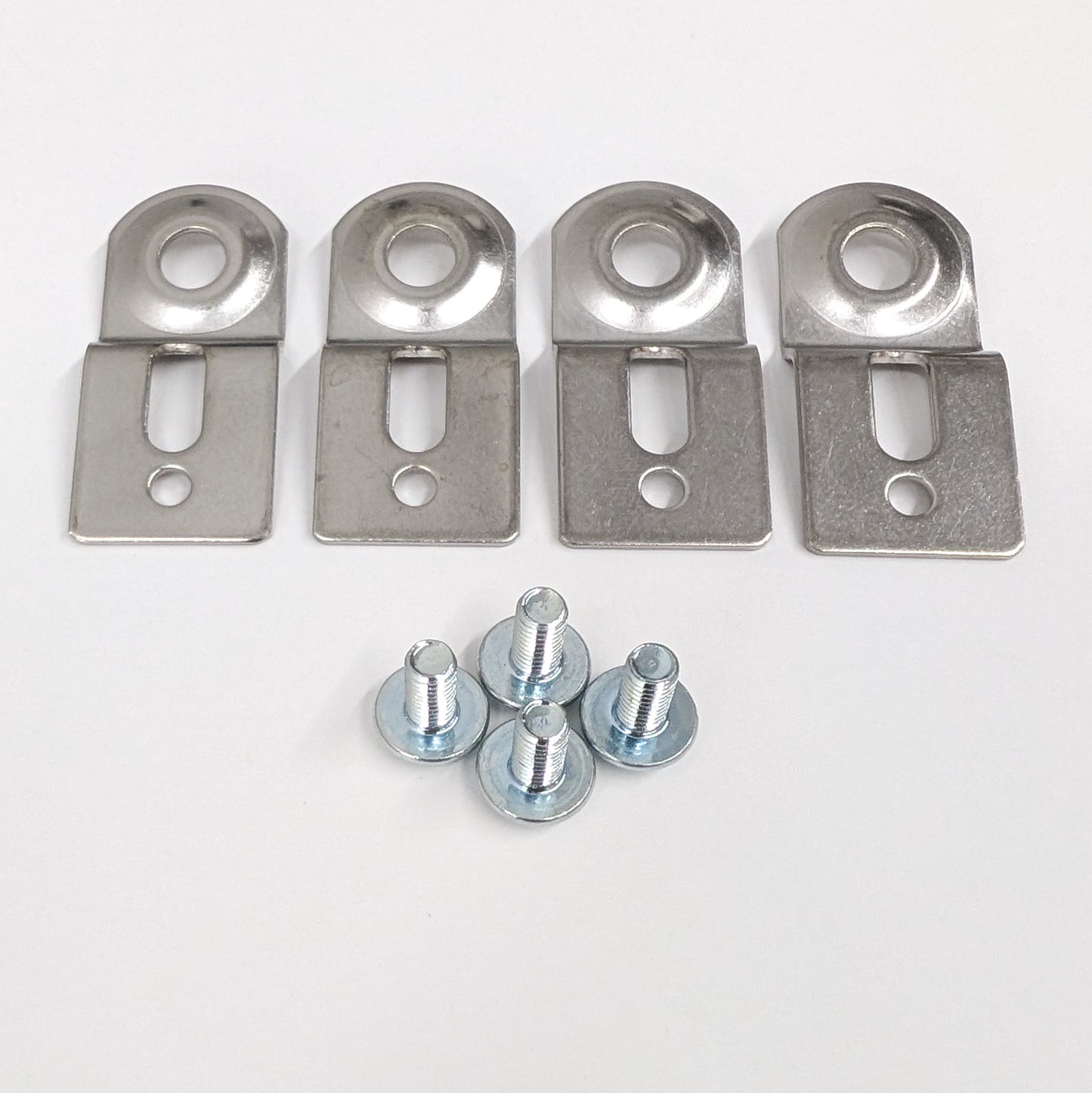 Set of four metal mounting brackets and with screws on a white background