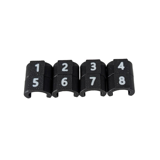 Close-up of black cable ID clips with white numbers 1-8 on a white background