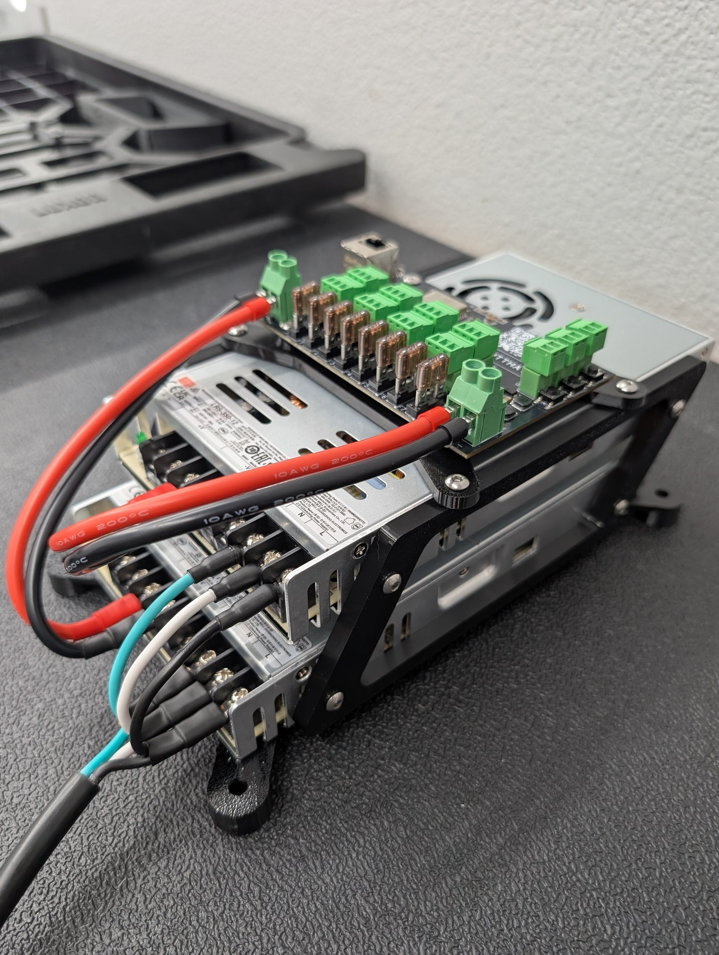 Close up of two power supplies with Baldrick8 RGB pixel controller board mounted on top