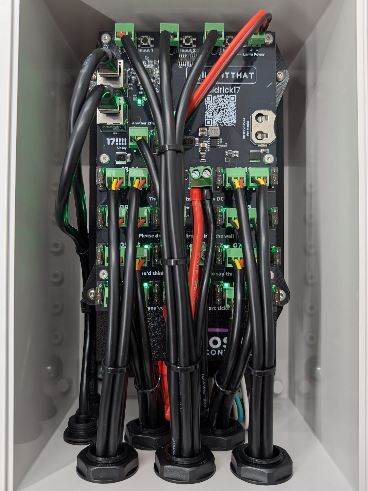 Close up of Baldrick17 board mounted inside grey plastic enclosure with red and black power wires running to it.