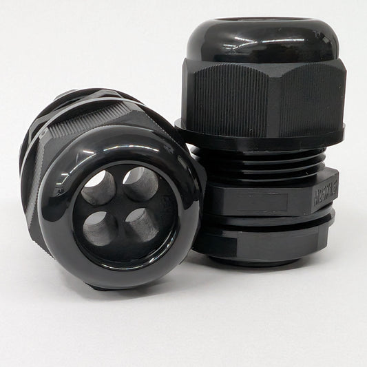 Two black nylon 4-hole cable gland connectors on a white background