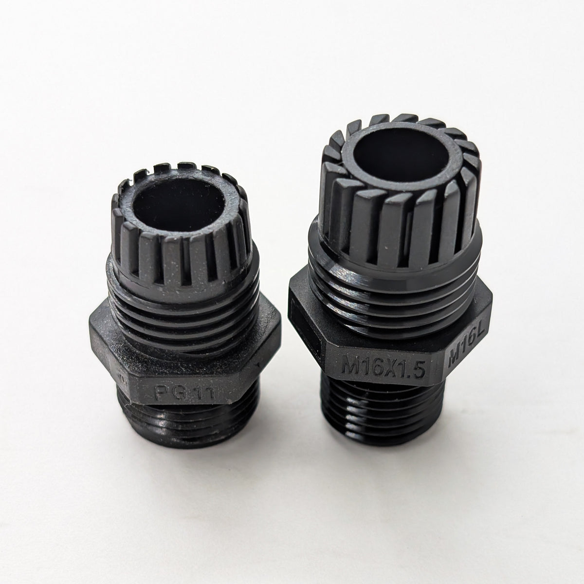 Side-by-side comparison of an M16L long-thread cable gland and a PG11 cable gland showing differences in body size, sealing nut size, and overall construction
