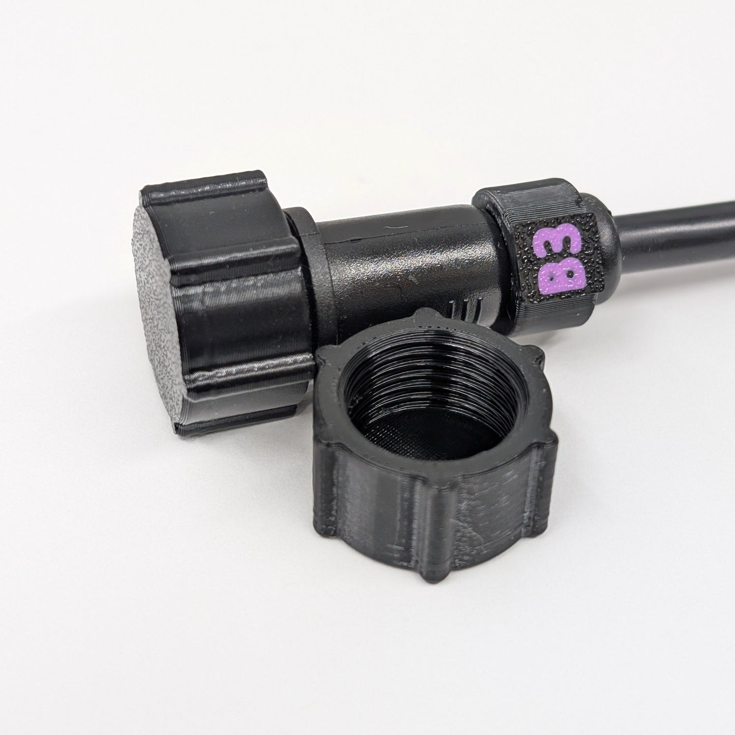 Black female xConnect plug in front of a capped pigtail wire on a white background