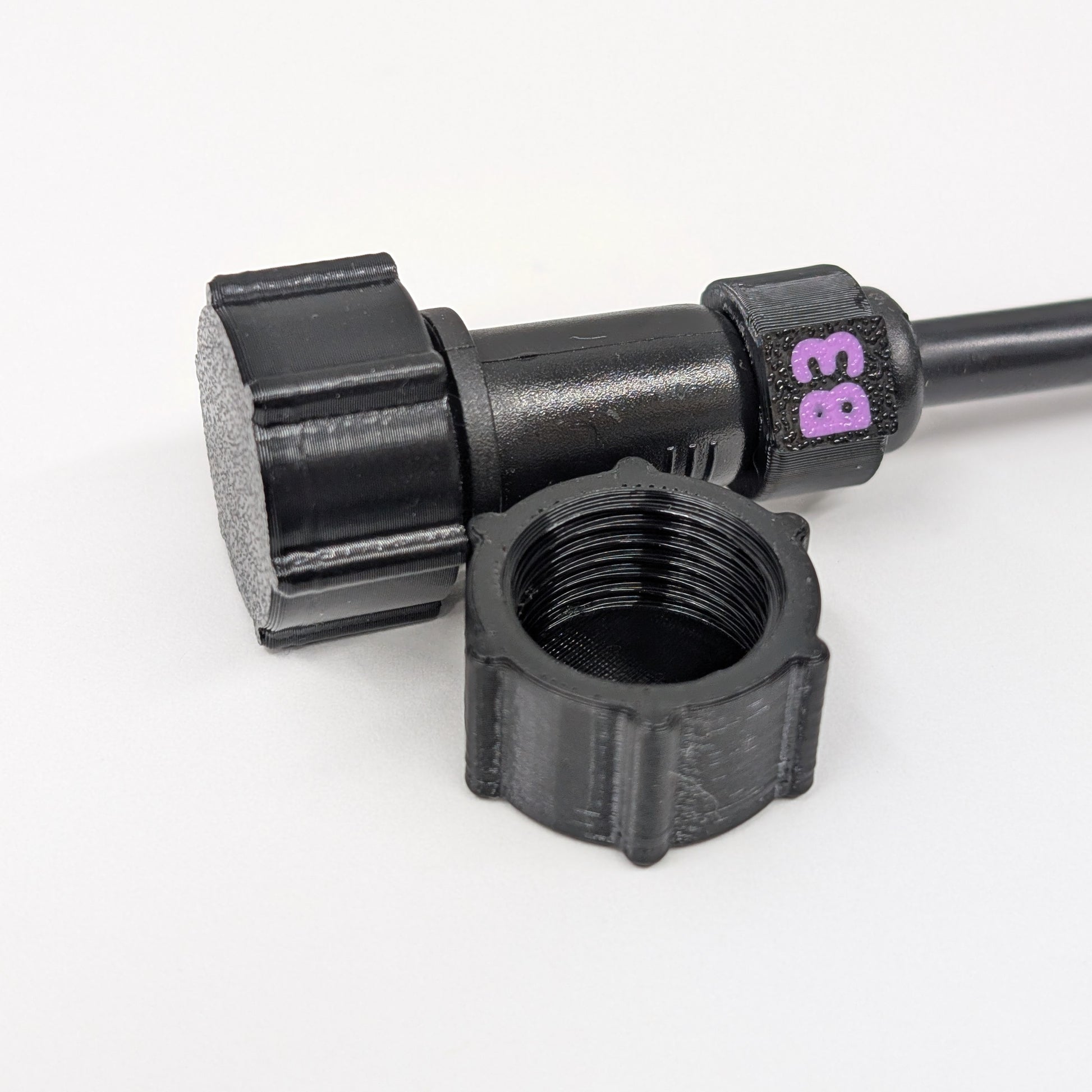 Black female xConnect plug in front of a capped pigtail wire on a white background