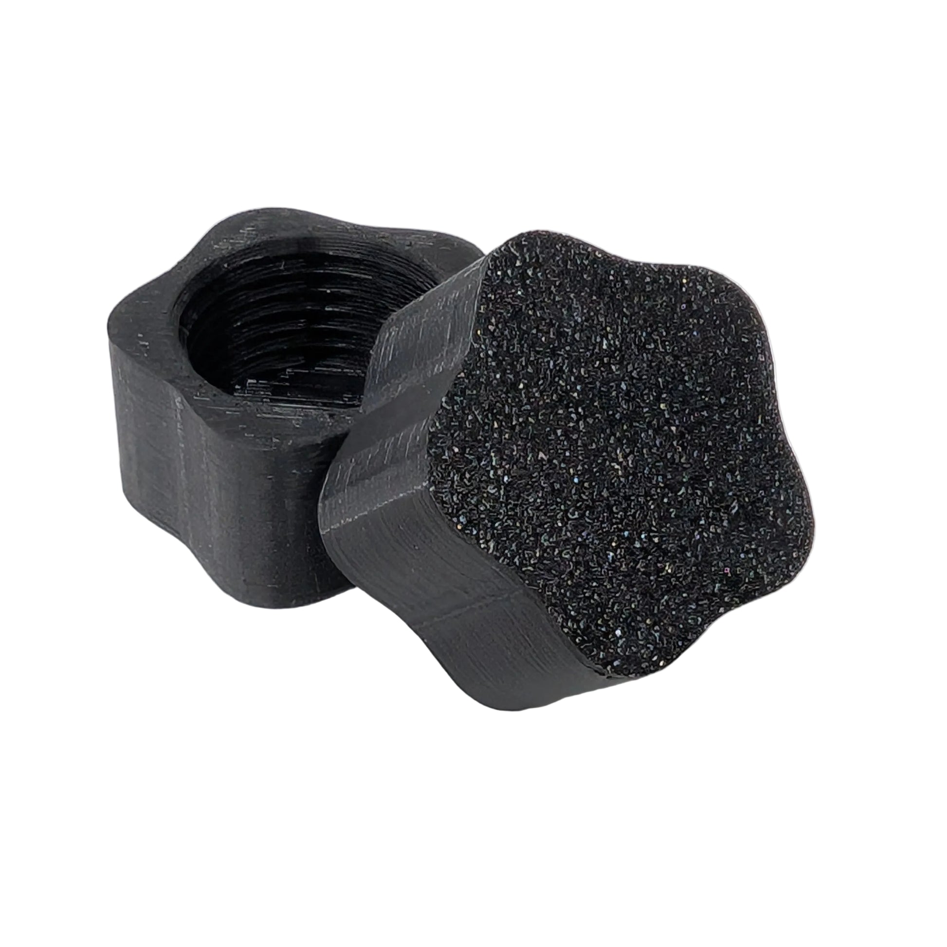 Star shaped black plastic threaded xConnect cap on a white background