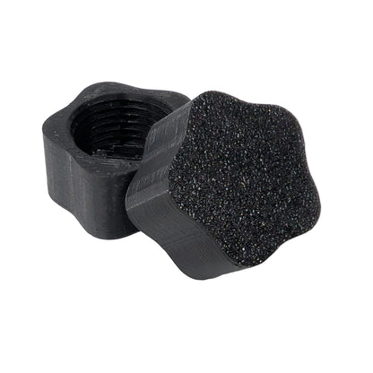 Star shaped black plastic threaded xConnect cap on a white background