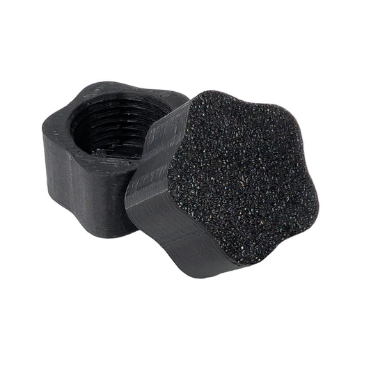 Star shaped black plastic threaded xConnect cap on a white background